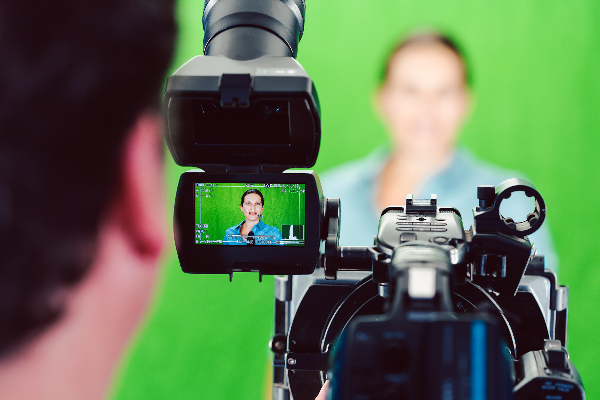TV production crew filming using a green screen
